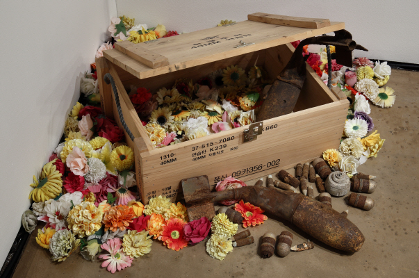 Flower-Shade, 2017, Wooden ammunition box, projectiles and ammunitions, articial owers, Size variable